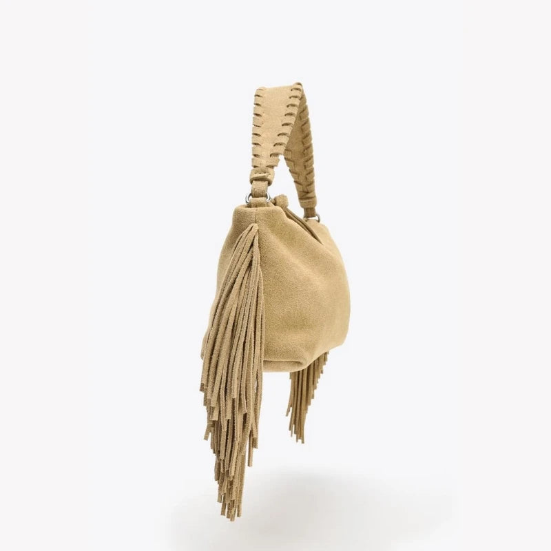 Compact crossbody bag with tassels.