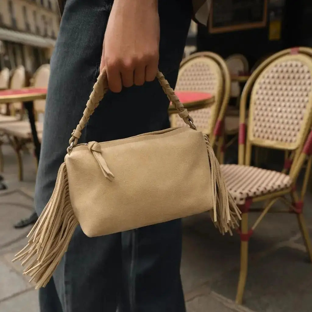 Compact crossbody bag with tassels.
